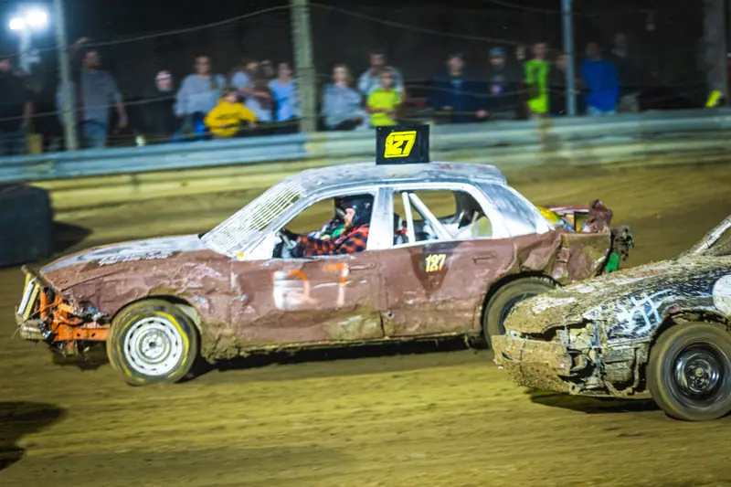 Enduro cars battling at night during Cornfield Crash for Cash
